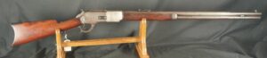079-0825-D0251, Winchester M-1876 2nd model Round Barrel Rifle with thumb print dust cover. BUY NOW